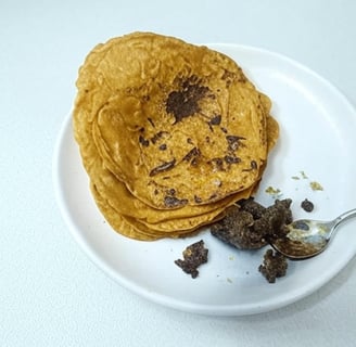 alt="Besan Chilla served with homemade pickle on a white plate"