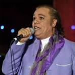 a man in a purple suit and tie dye dyed with a purple scarf
