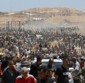 a closed border crossing with aid trucks stalled