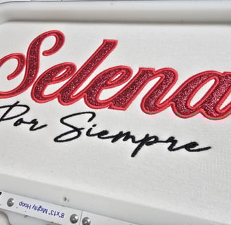Selena Por Siempre embroidery in glittered red and black script on white fabric – San Antonio