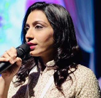 a woman in a white shirt and a microphone