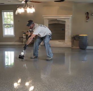 man applying epoxy finish on floor
