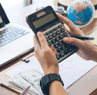 a person holding a calculator and a calculator