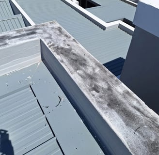 Roof flashing lifted near parapet wall