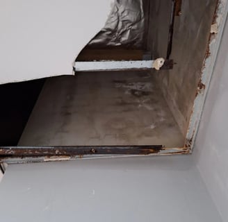 Ceiling water damage caused by slab joint leak and failed roof membrane