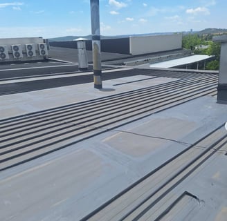 Advanced waterproofing procedures on metal IBR roof system, Lonehill Shopping Centre, Fourways