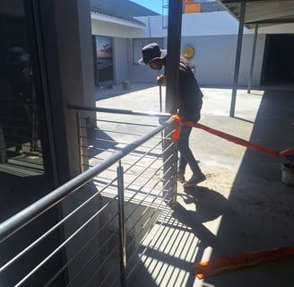Ensuring clearing of fine debris after waterproof screed application, Harbor Bay Mall, Cape Town