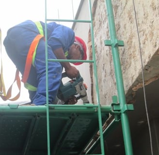 Mechanical stripping of compromised exterior plaster for waterproofing works, Sandhurst Towers, Sandton