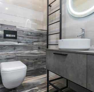 Modern grey-tiled bathroom with floating vanity