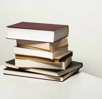 A stack of books used to show the folly of perfection