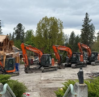Five excavators in a row