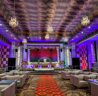a large room with a stage set up for a wedding