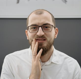 a man with a beard and glasses on his face