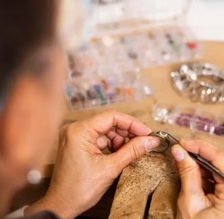 Jeweler hands putting a jewel on ring