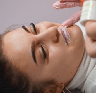 Eine Frau, die ihre Lippen von einer professionellen Kosmetikerin mit Permanent Make-up 