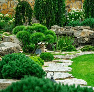 a garden with a stone path leading to a stone path