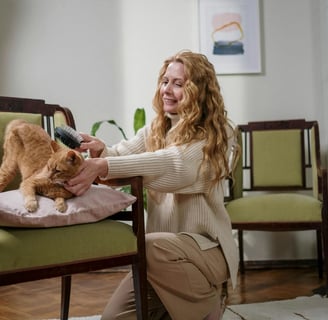 woman grooming a cat
