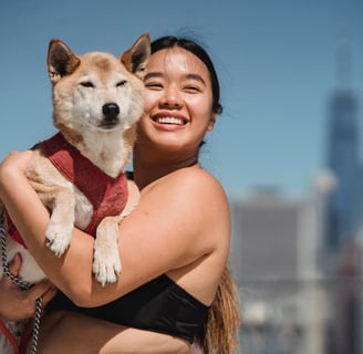 A woman cuddling her dog