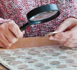 Grading Coin Viewing With Magnifying Glass