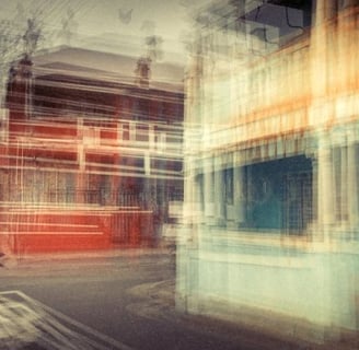 Abstract multiple exposure photograph of a man crossing a street with historic buildings in vibrant colours