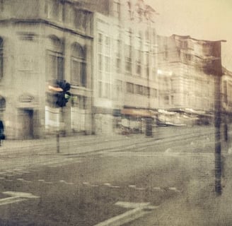 Abstract fine art photograph by Martin Osner showing a blurred urban street scene with historic buildings and a lone figure