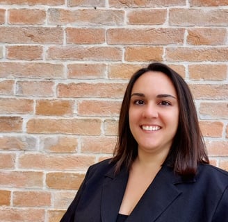 Italian language tutor, smiling warmly in a professional setting. Passionate about
