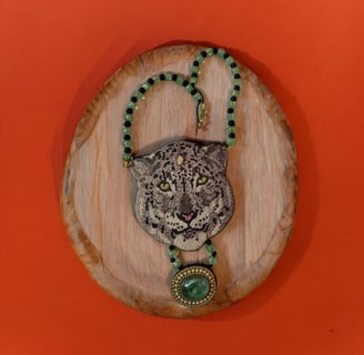 a leopard head with a necklace with a leopard head