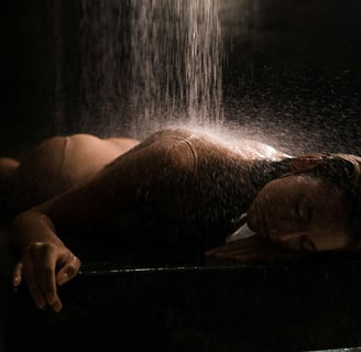 a woman in a bikini top is taking a shower