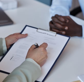 a man holding a pen and writing in board