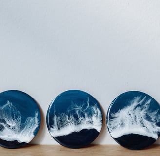 three plates with waves on it with the paint