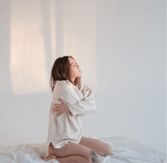 a girl folding her hands around her body
