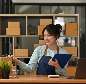 a girl holding pen and board doing work