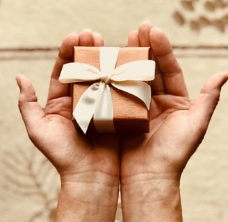 holding a small gift box in both hands
