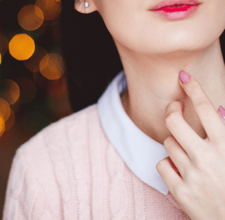 girls hand on her neck