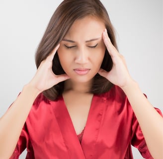 a women  holding her head 