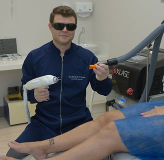 a man in sunglasses and sunglasses is sitting on a chair