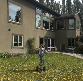 a man is using a hose to clean the lawn