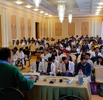 a large room with a lot of people sitting at tables
