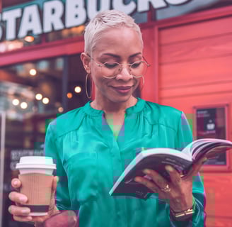 a woman in a green shirt is reading a book