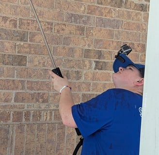 Ruby Working to clean the ceiling of a walk around porch.
