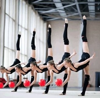 Rhythmic gymnasts is performing a routine with five balls