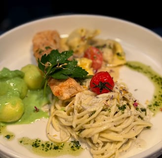 a plate of pasta with shrimp and vegetables