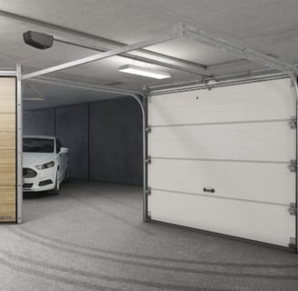 a car parked in a garage with a white car