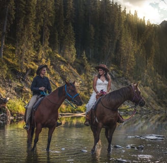 Bride and groom on horses in banff backcountry