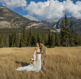 a bride and groom standing in a field in banff