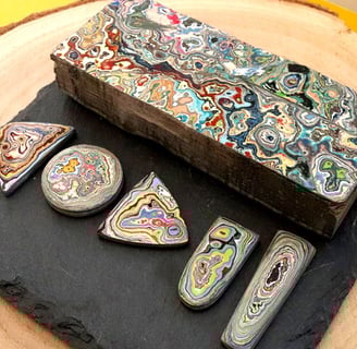 a rock slab of graffiti wall, that has been cut into cabochons to be used in jewellery 