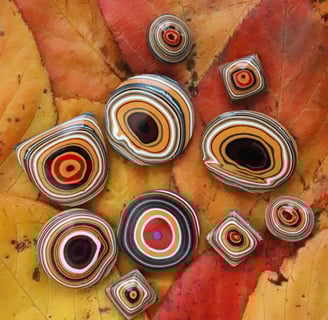 a selection of bright orange jeep fordite cabochons