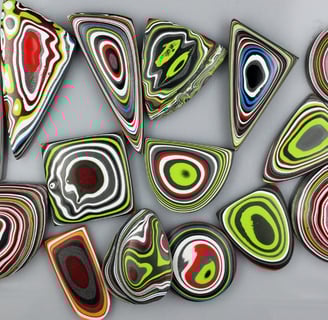 "Multicolored Fordite cabochons with swirling layers from vintage automotive paint"