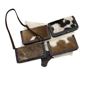 a pair of two leather wallets with a cowhide hideaway pouch