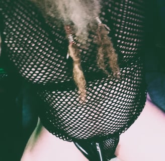 a man dressed in a mesh top in a g-string